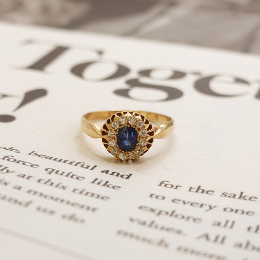 Gold ring with a blue gemstone on a newspaper background