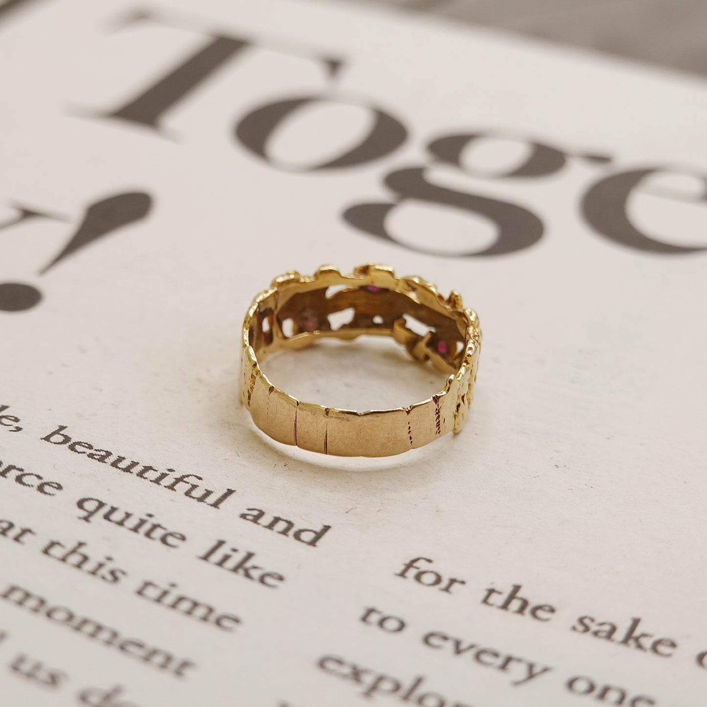 Gold ring on a book page with text