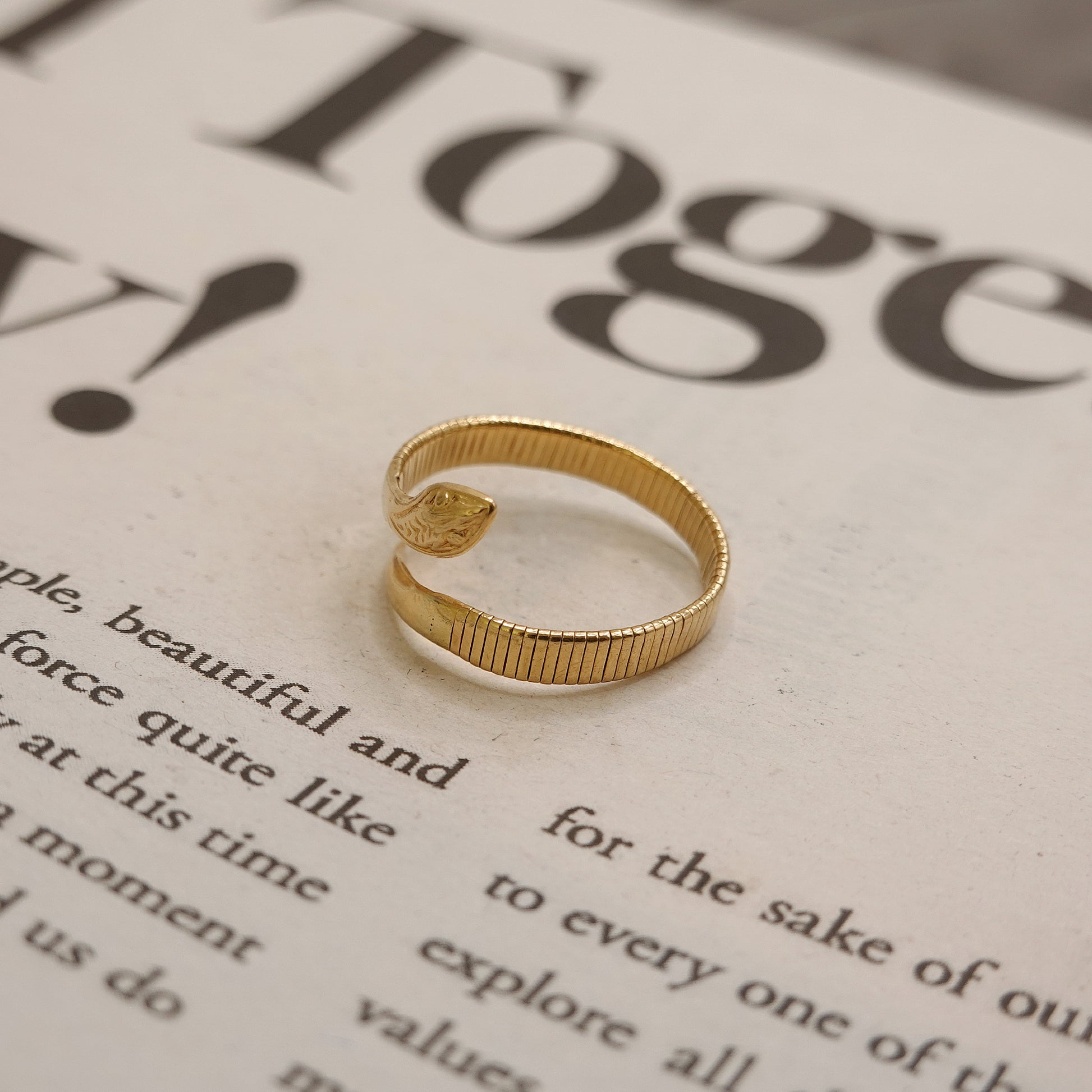 Gold ring on a piece of paper with text