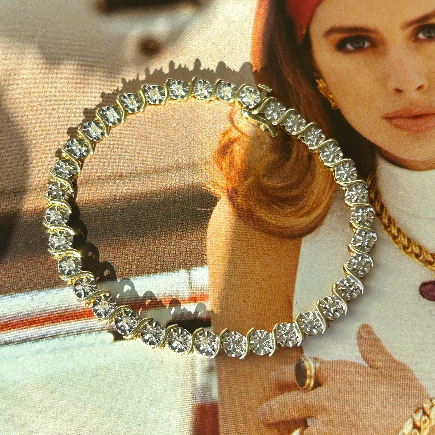 Woman wearing a large diamond necklace with a blurred background