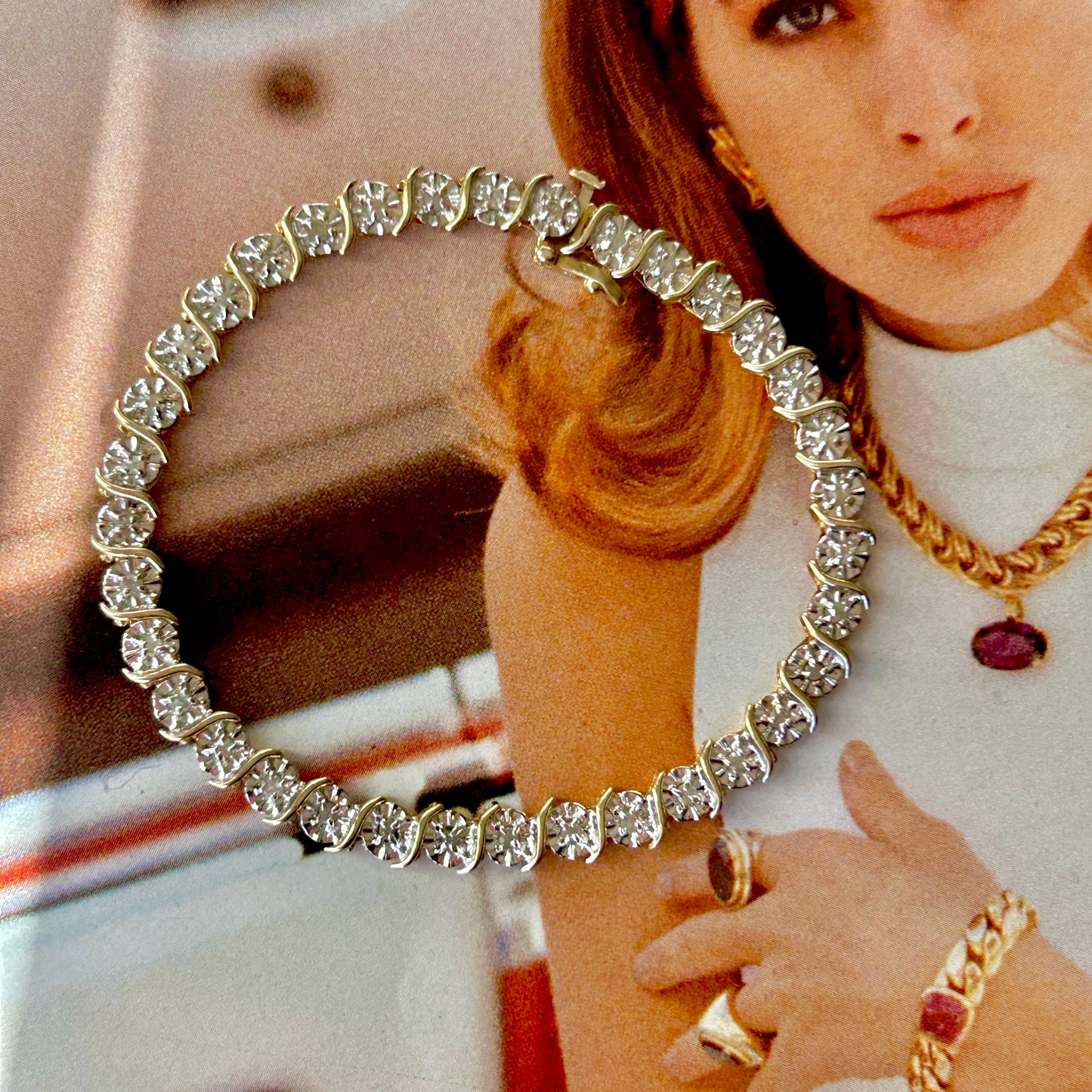 Close-up of a woman wearing a sparkling necklace with a blurred background