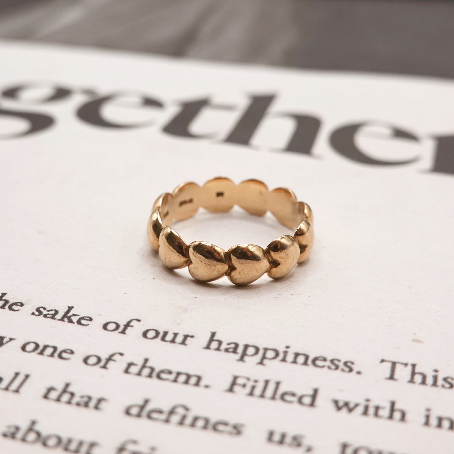 Gold ring on a piece of paper with text