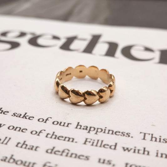 Gold ring on a piece of paper with text